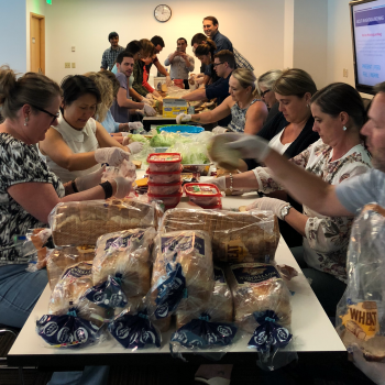 Employees make lunches for distribution to a youth program in South Seattle with #HashtagLunchbag.